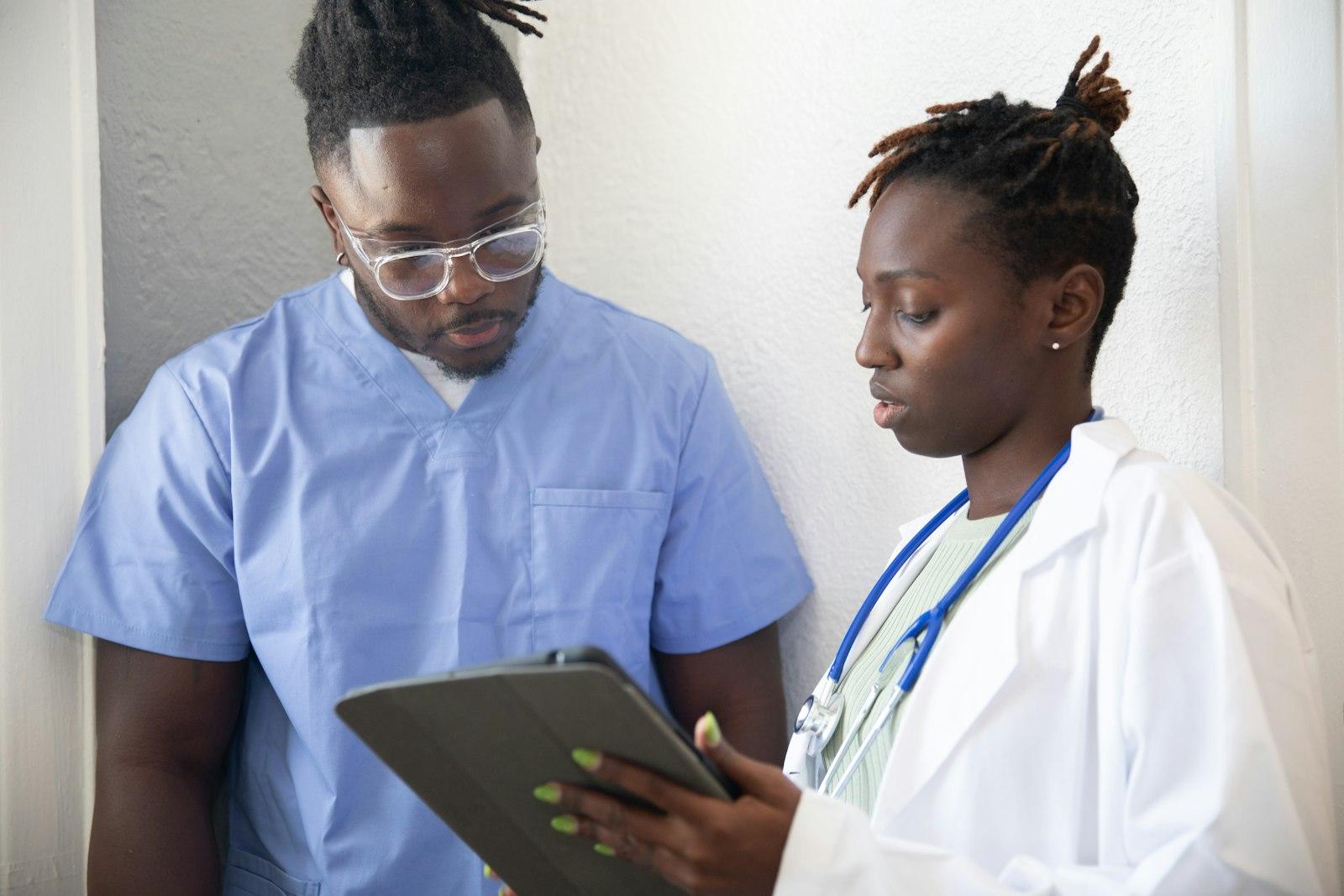 Two South African healthcare workers reviewing patient information together.